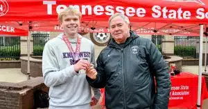 A Tennessee youth soccer player is awarded a championship medal.